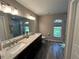 Luxurious bathroom featuring a double sink vanity, granite countertops, and a glass-enclosed shower at 3064 S Us Highway 41, Dunnellon, FL 34432