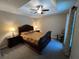 Relaxing bedroom featuring traditional furnishings, carpet, and a ceiling fan for a cozy retreat at 3064 S Us Highway 41, Dunnellon, FL 34432