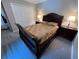Comfortable bedroom showcasing a patterned carpet, ceiling fan, and traditional furniture at 3064 S Us Highway 41, Dunnellon, FL 34432