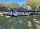 Spacious home with a large yard, showcasing the side elevation and lush greenery around the property at 3064 S Us Highway 41, Dunnellon, FL 34432