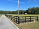 Well-maintained black wooden fencing lining the property's edge, enhancing curb appeal and privacy at 3064 S Us Highway 41, Dunnellon, FL 34432