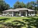 Charming single-story home featuring a well-manicured lawn and beautifully landscaped front yard at 3064 S Us Highway 41, Dunnellon, FL 34432