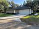 Home exterior featuring a two-car garage and a long driveway at 3064 S Us Highway 41, Dunnellon, FL 34432