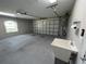 Clean garage with a utility sink, automatic garage door opener and an exterior window to let in sunlight at 3064 S Us Highway 41, Dunnellon, FL 34432