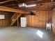 View of the garage with exposed wooden beams and stairs leading to the upper level at 3064 S Us Highway 41, Dunnellon, FL 34432