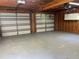 Spacious unfinished garage with gray flooring and two large overhead doors at 3064 S Us Highway 41, Dunnellon, FL 34432