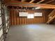 Spacious unfinished garage features exposed beams, a window, and wall-mounted storage cabinets at 3064 S Us Highway 41, Dunnellon, FL 34432