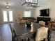 Living room with a dining area, with large windows, and a stylish decor at 3064 S Us Highway 41, Dunnellon, FL 34432
