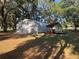 Exterior view of an outbuilding providing storage or workspace on a treed lot at 3064 S Us Highway 41, Dunnellon, FL 34432
