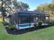 Beautiful backyard pool area featuring a screened enclosure and fresh landscaping at 3064 S Us Highway 41, Dunnellon, FL 34432