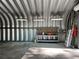 Interior of metal outbuilding featuring workspace, lighting and roll up door at 3064 S Us Highway 41, Dunnellon, FL 34432