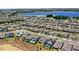 Wide aerial view showcasing homes, a lake, and green spaces within the community at 3294 Hanging Tide St, Winter Garden, FL 34787