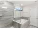Bathroom featuring a glass shower and separate soaking tub at 3294 Hanging Tide St, Winter Garden, FL 34787