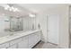 Bathroom featuring a double vanity, tile floors, and a glass shower at 3294 Hanging Tide St, Winter Garden, FL 34787