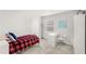 Neutral bedroom featuring a simple bed, a minimalist desk, and a bright window at 3294 Hanging Tide St, Winter Garden, FL 34787