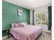 Comfortable bedroom with a queen bed, a modern wall color, and a large window for natural light at 3294 Hanging Tide St, Winter Garden, FL 34787