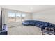Bonus room featuring neutral carpet, natural light and a large velvet couch at 3294 Hanging Tide St, Winter Garden, FL 34787