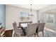 Bright dining room featuring stylish chairs, a tufted bench, and natural light from large windows at 3294 Hanging Tide St, Winter Garden, FL 34787