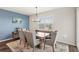 Cozy dining area with a tufted bench, stylish chairs, decorative chandelier, and ample natural light at 3294 Hanging Tide St, Winter Garden, FL 34787