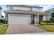 Charming two-story home with a brick driveway and a two-car garage at 3294 Hanging Tide St, Winter Garden, FL 34787