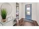 Bright foyer with wood floors, stylish décor, and a view into the adjacent bedroom at 3294 Hanging Tide St, Winter Garden, FL 34787