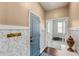 Cozy hallway with decorative wainscoting and an open doorway to a bright exercise room at 3294 Hanging Tide St, Winter Garden, FL 34787