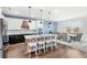 Modern kitchen with a large island, pendant lighting, stainless steel appliances, and dining area at 3294 Hanging Tide St, Winter Garden, FL 34787