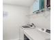 Bright laundry room with modern washer and dryer, and convenient shelving for storage at 3294 Hanging Tide St, Winter Garden, FL 34787