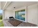 A neutral brick patio space is furnished with a love seat and rug at 3294 Hanging Tide St, Winter Garden, FL 34787