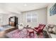 Sitting area showcasing stylish armchairs, patterned rug, hardwood floors and natural light at 3294 Hanging Tide St, Winter Garden, FL 34787