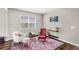 Sitting area showcasing stylish armchairs, patterned rug, hardwood floors and natural light at 3294 Hanging Tide St, Winter Garden, FL 34787