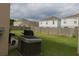 Large backyard featuring lush green grass and a view of neighboring houses under a cloudy sky at 358 Fairfield Dr, Sanford, FL 32771
