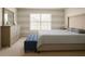Cozy bedroom with carpet flooring, a large bed, dresser and a window with blinds at 358 Fairfield Dr, Sanford, FL 32771