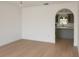 Bright dining room with light wood floors and an arched entry to the adjacent kitchen at 358 Fairfield Dr, Sanford, FL 32771