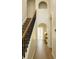 Hallway featuring hardwood floors, staircase with black railings, and neutral walls at 358 Fairfield Dr, Sanford, FL 32771