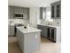 Stylish kitchen with modern appliances, shaker cabinets, a wine cooler and quartz countertops at 358 Fairfield Dr, Sanford, FL 32771