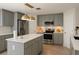 Beautiful kitchen featuring stainless steel appliances, light grey cabinetry, and a center island at 358 Fairfield Dr, Sanford, FL 32771