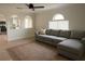 Bright living room featuring an oversized couch, light wood floors, and arched doorways at 358 Fairfield Dr, Sanford, FL 32771