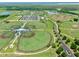 Aerial view of a sports complex with baseball fields, parking lots, and trees at 3945 Angola Ln, Sanford, FL 32771