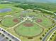 Aerial view of a sports complex featuring multiple baseball fields, trees, and parking at 3945 Angola Ln, Sanford, FL 32771