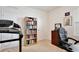 Carpeted bedroom features a bookshelf, workstation, and a treadmill at 3945 Angola Ln, Sanford, FL 32771