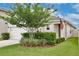 Attractive home with a tidy lawn, a decorative tree, and an American flag waving near the entrance at 3945 Angola Ln, Sanford, FL 32771