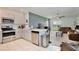 Open kitchen flows into the living area, featuring stainless steel appliances and sleek countertops at 3945 Angola Ln, Sanford, FL 32771