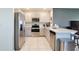Well-equipped kitchen boasts modern stainless steel appliances, light cabinetry, and ample counter space at 3945 Angola Ln, Sanford, FL 32771