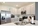Well-lit kitchen features stainless steel appliances, double sink, and ample counter space at 3945 Angola Ln, Sanford, FL 32771