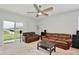 Spacious living room boasts plush carpet, neutral walls, and sliding doors to the backyard at 3945 Angola Ln, Sanford, FL 32771