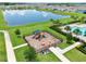 Aerial view of a playground and community pool with a lake and houses at 3945 Angola Ln, Sanford, FL 32771