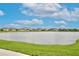Scenic view of a pond surrounded by well-maintained houses in a quiet neighborhood at 3945 Angola Ln, Sanford, FL 32771