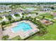 Aerial view of a sparkling community pool, playground, and green space in a residential neighborhood at 3945 Angola Ln, Sanford, FL 32771