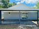 Back porch with sliding glass door and wood decking offers outdoor living space at 412 Editha Cir, Sanford, FL 32771